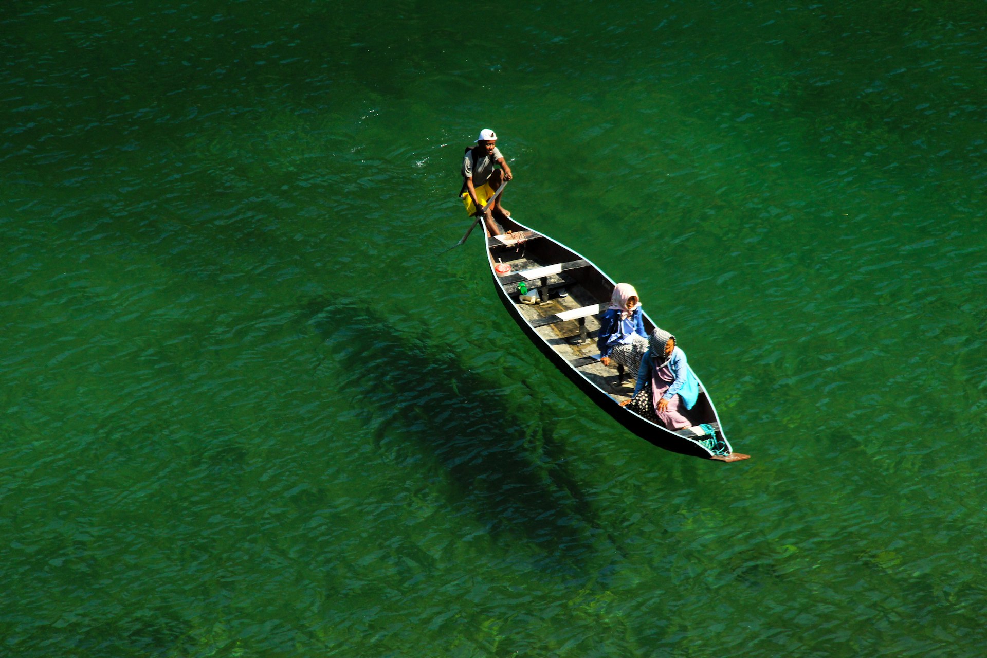 Dawki Crystal Clear River In Asia two person on boat